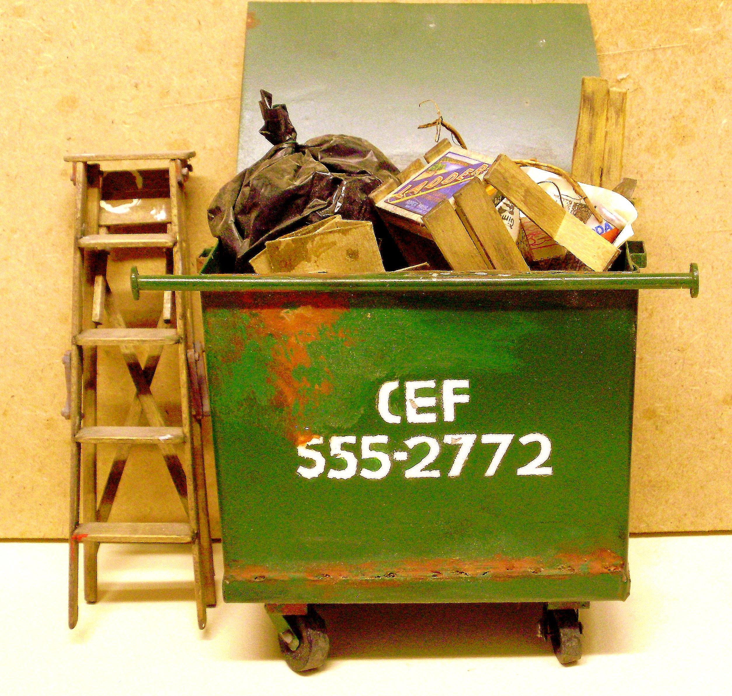 hand made metal 1:12 scale dollhouse miniature dumpster, turning and swiveling wheels, working lid.